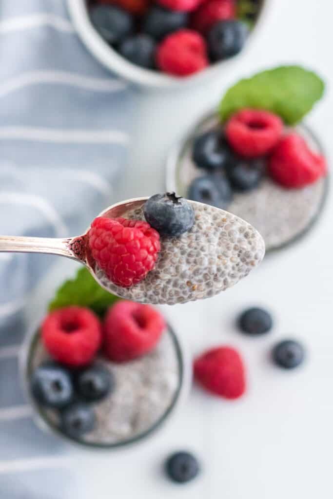 bite of chia seed pudding with fresh berries on spoon