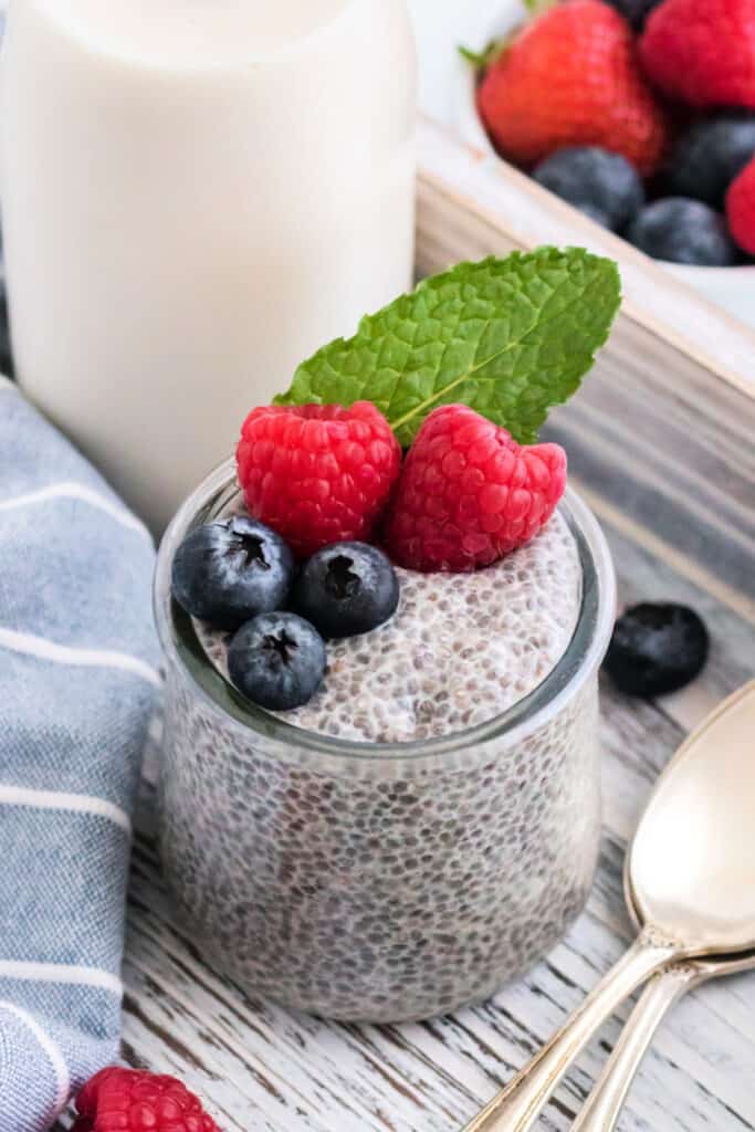 chia seed pudding in glass jar garnished with fresh berries