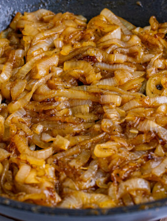 closeup of coca cola caramelized onions in pan