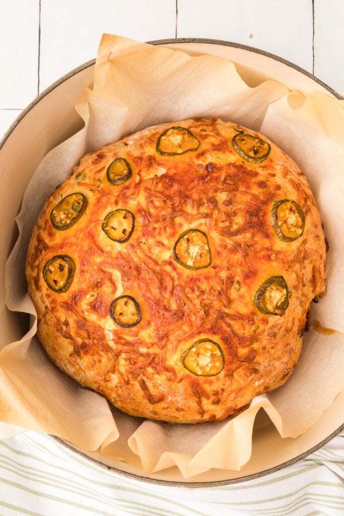 looking down into a dutch oven with freshly made jalapeno cheddar bread