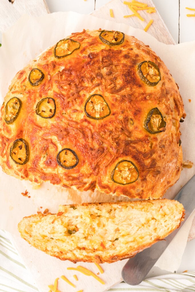 loaf of jalapeno bread with a slice cut from it