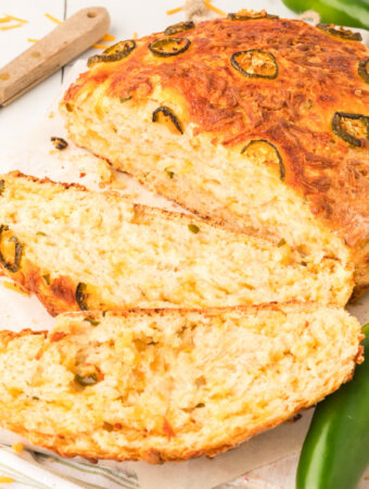 closeup up of jalapeno cheddar bread with a couple of slices cut