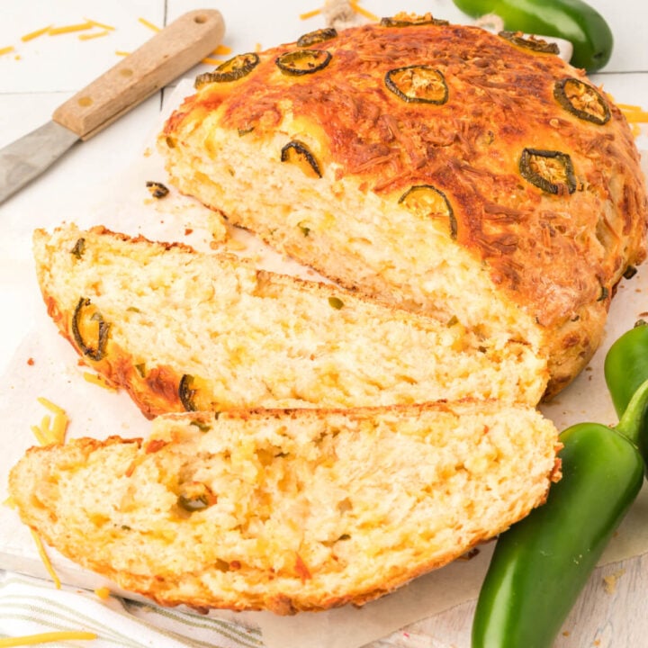 closeup up of jalapeno cheddar bread with a couple of slices cut
