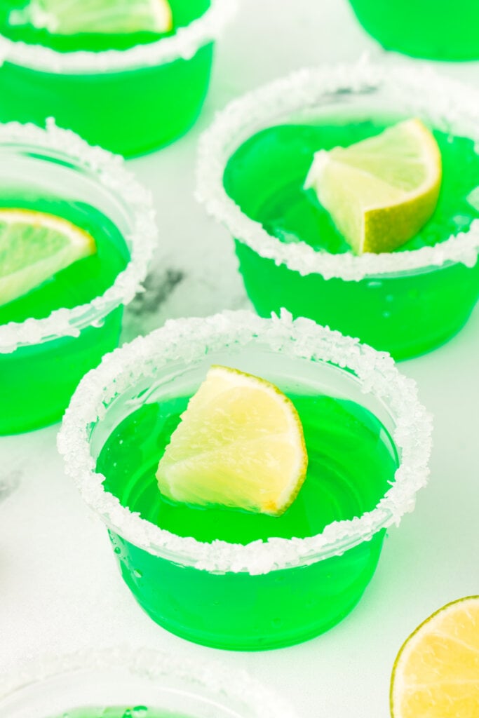 several lime margarita jello shots on a table