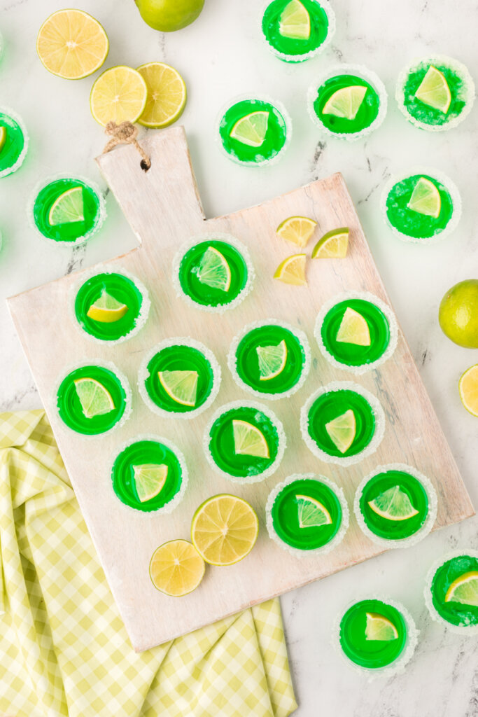 looking down onto a table spread with green margarita jello shots