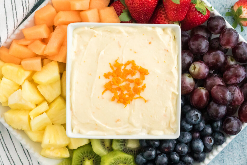 orange creamsicle fruit dip surrounded by fresh fruit