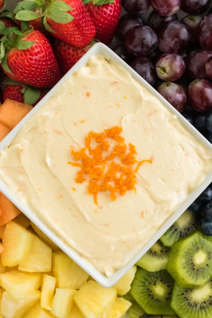 orange creamsicle fruit dip surrounded by assorted fresh fruit