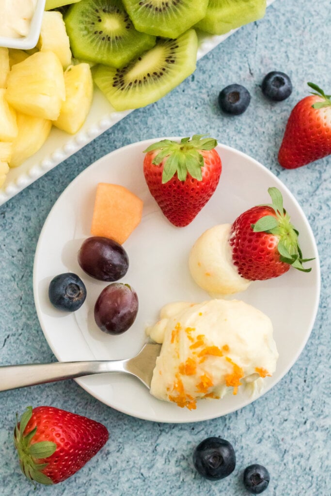 assorted fresh fruit on plate with a scoop of orange creamsicle fruit dip