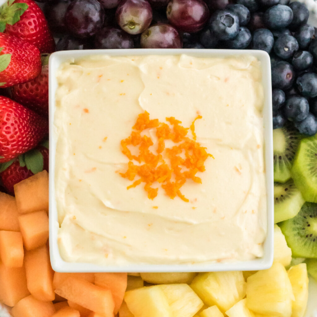 closeup of orange fruit dip in square bowl