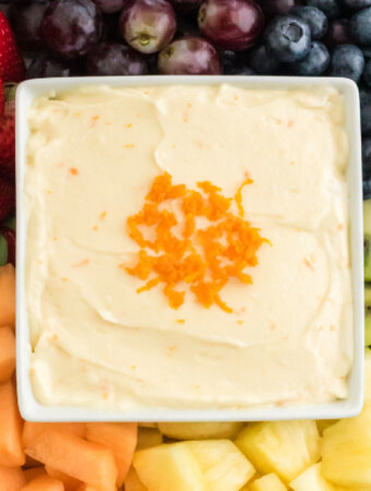 closeup of orange fruit dip in square bowl