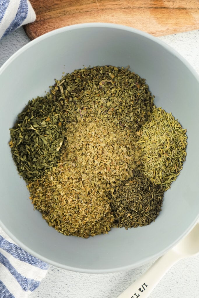 spices and herbs in bowl to make italian seasoning