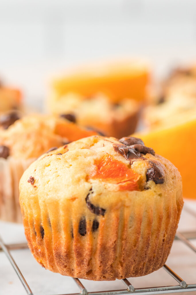 closeup of an orange muffin on a cooling rack