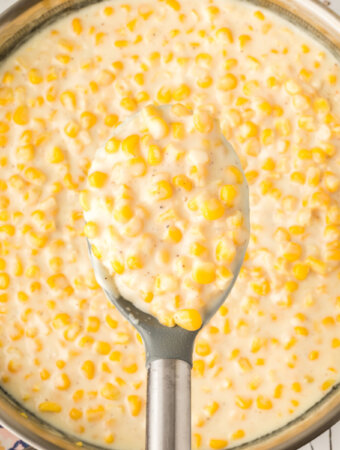 creamed corn scooped out of skillet onto spoon