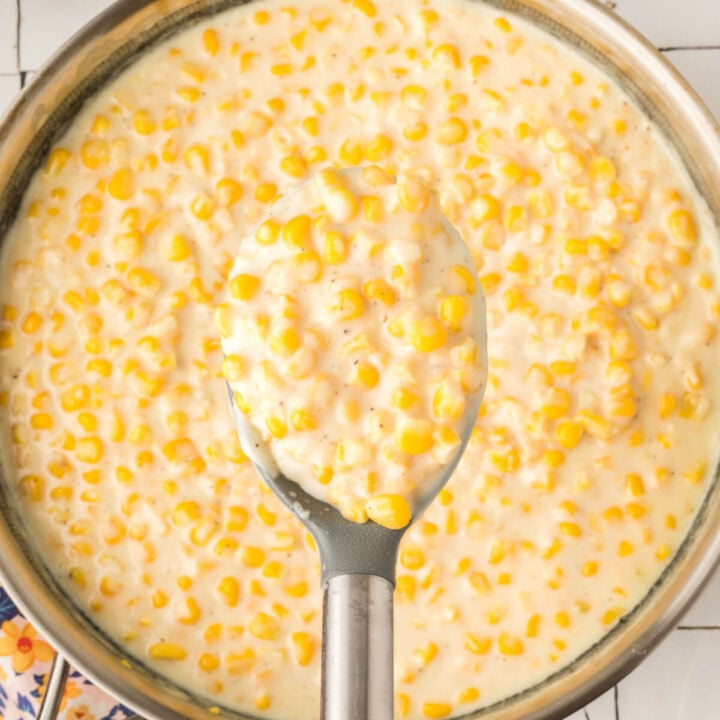 creamed corn scooped out of skillet onto spoon