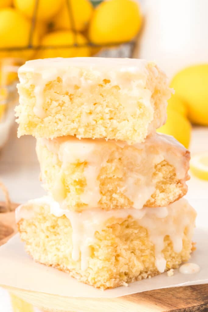 closeup of three lemon brownies stacked on top of each other