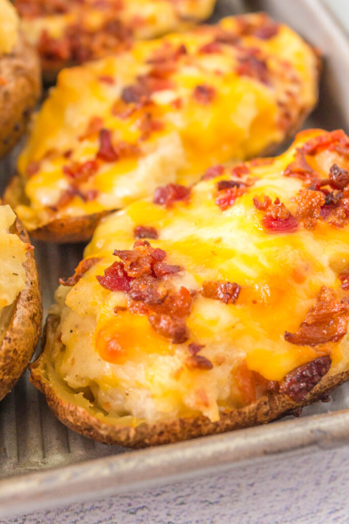 grilled twice baked potatoes on a baking sheet