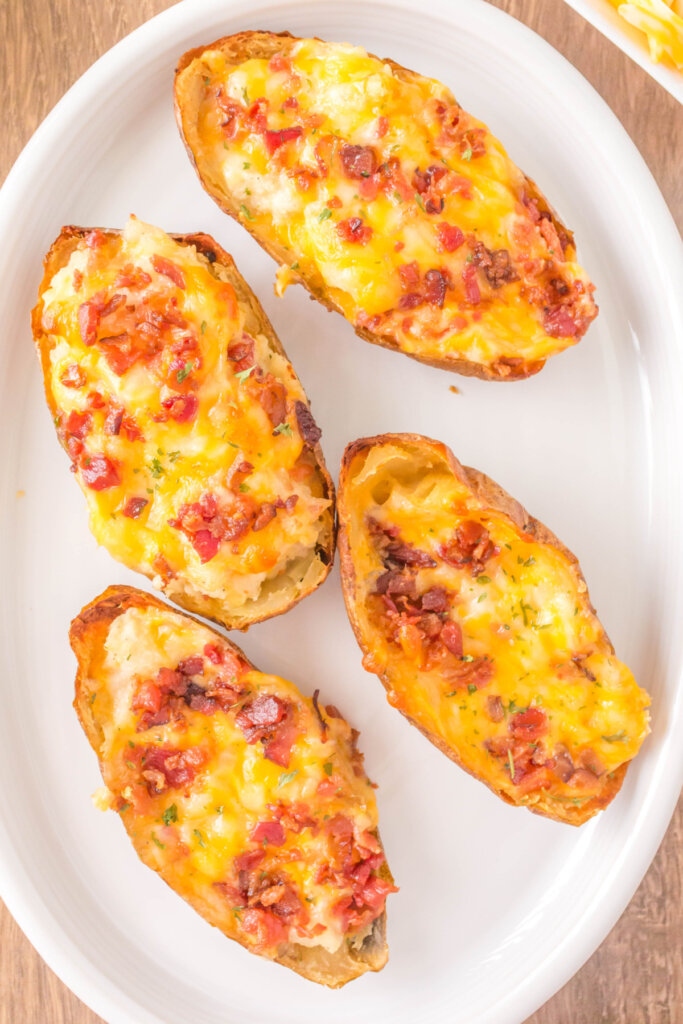 four twice baked potatoes on a platter