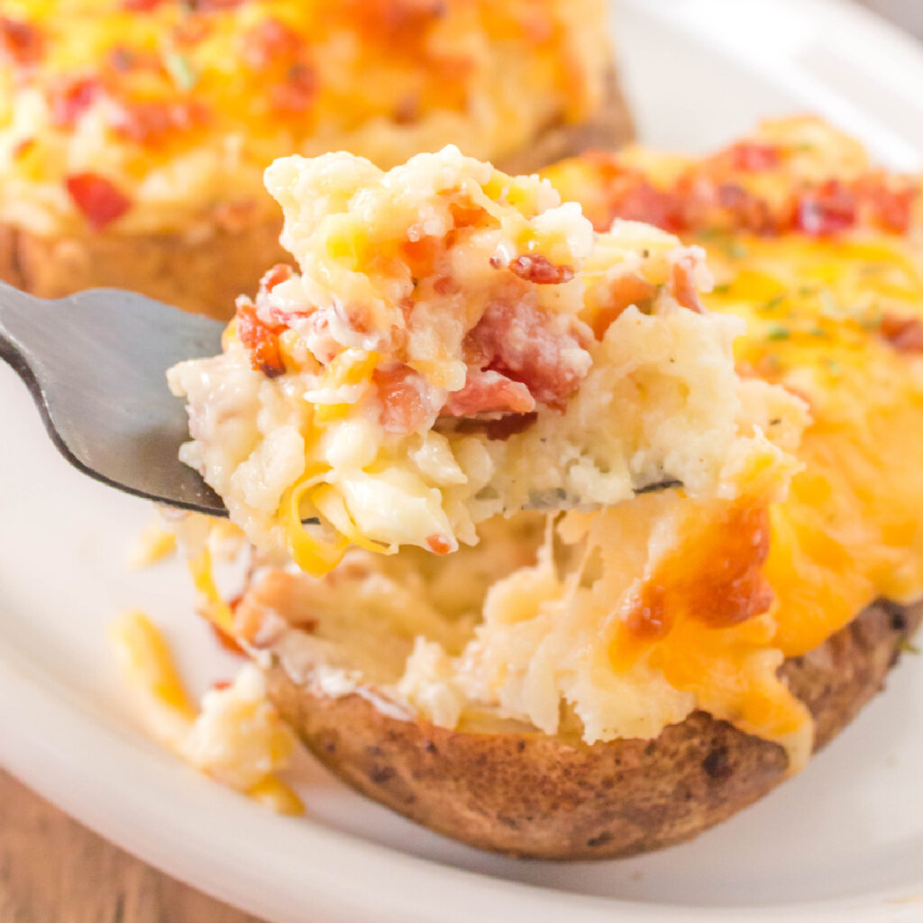 closeup of twice baked potato being scooped