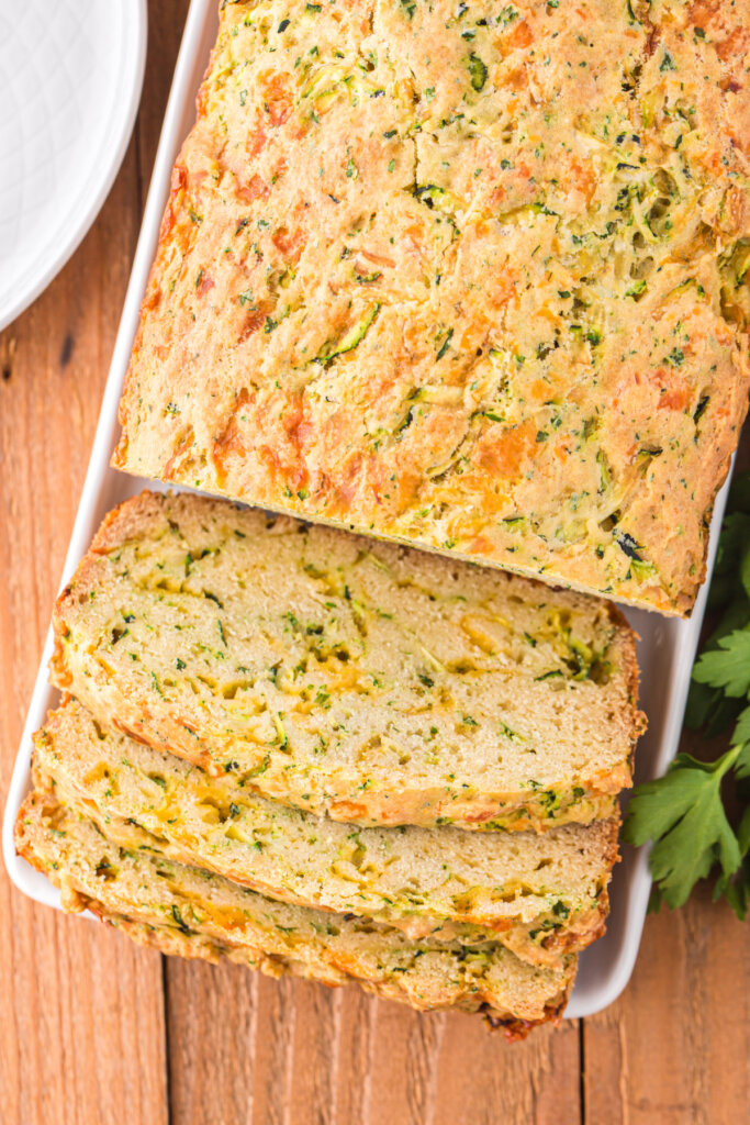 loaf of cheesy zucchin bread with slices cut