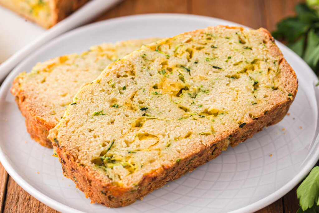 two slices of cheesy zucchini bread on white plate