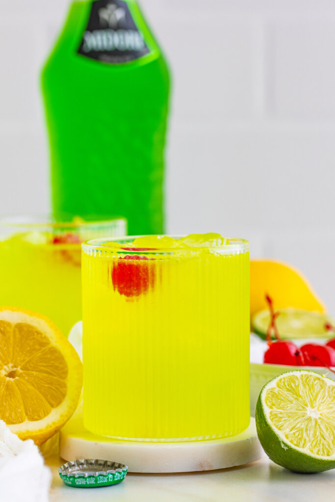 midori sour with a midori bottle in the background