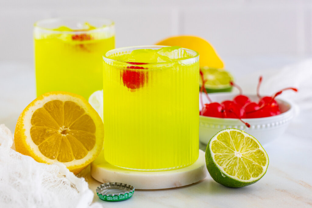 two midori sour cocktails on a table