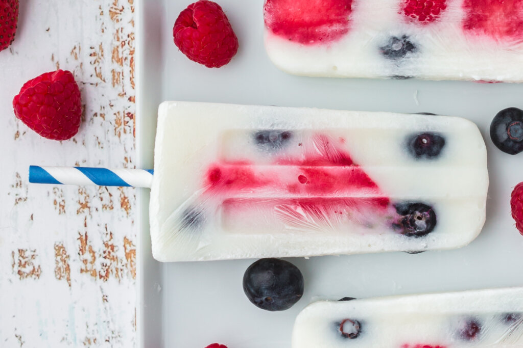patriotic berry popsicle laying on a white plate