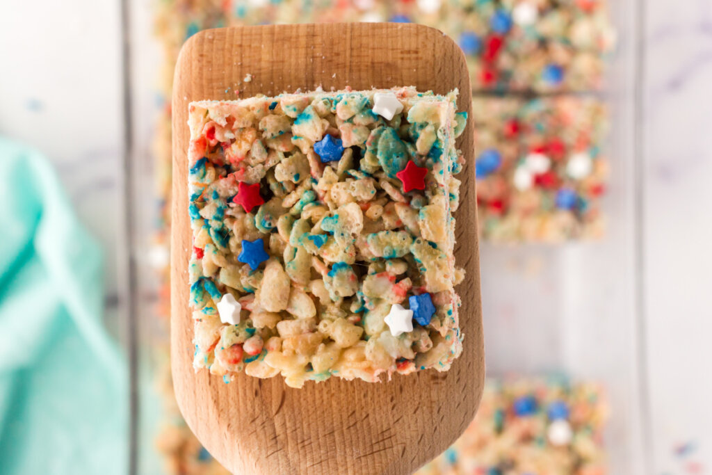 red white and blue rice crispy treat on wooden spatula