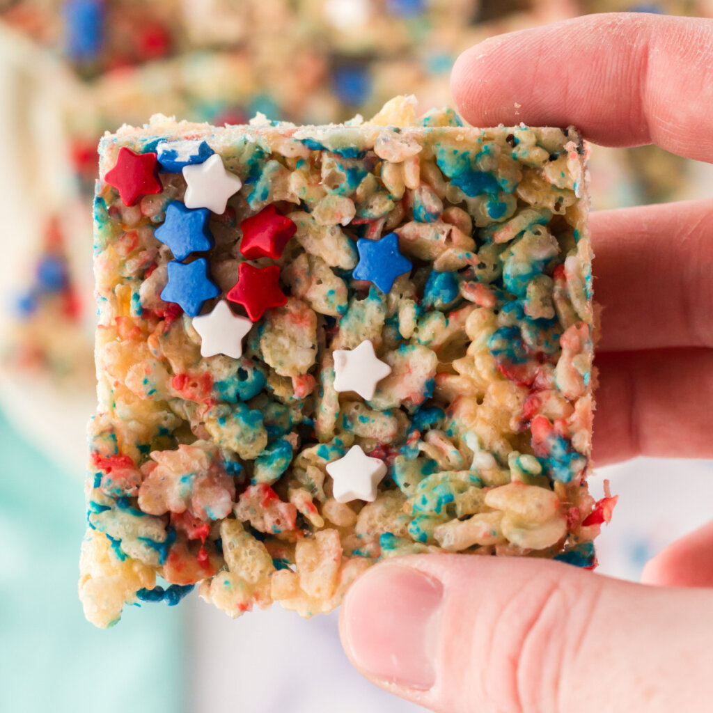 closeup of a hand holding a patriotic rice crispy treat