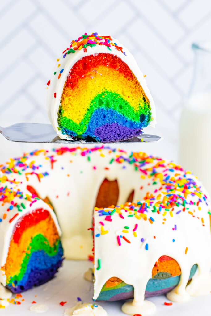 slice of rainbow bundt cake on a serving spatula