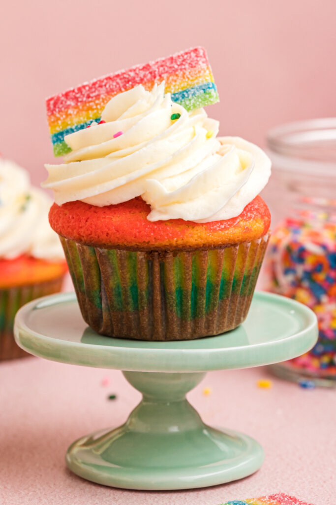 rainbow cupcake on cake stand