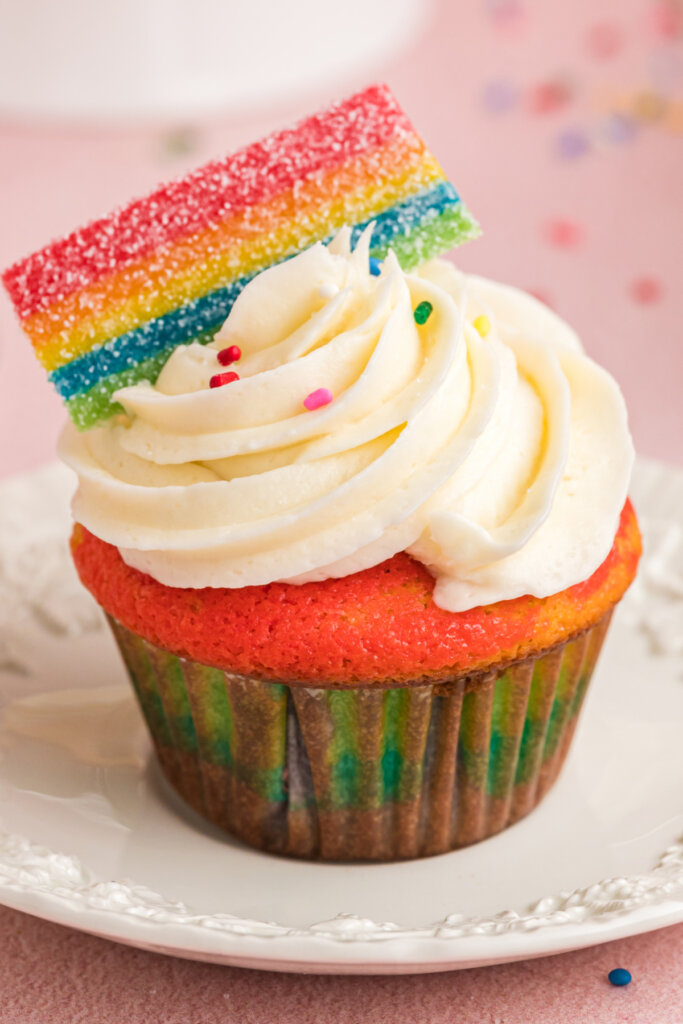 frosted rainbow cupcake on plate