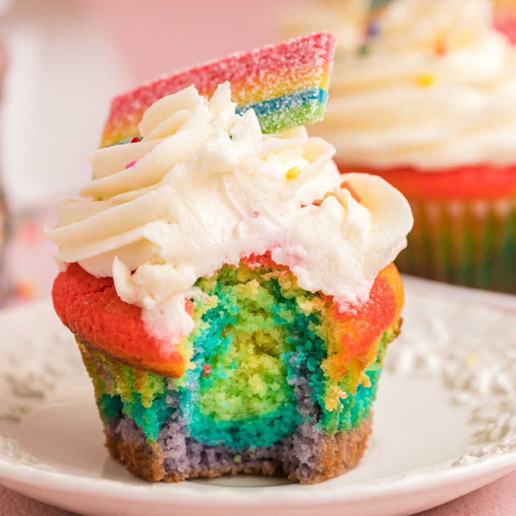 closeup rainbow cupcakes on plate