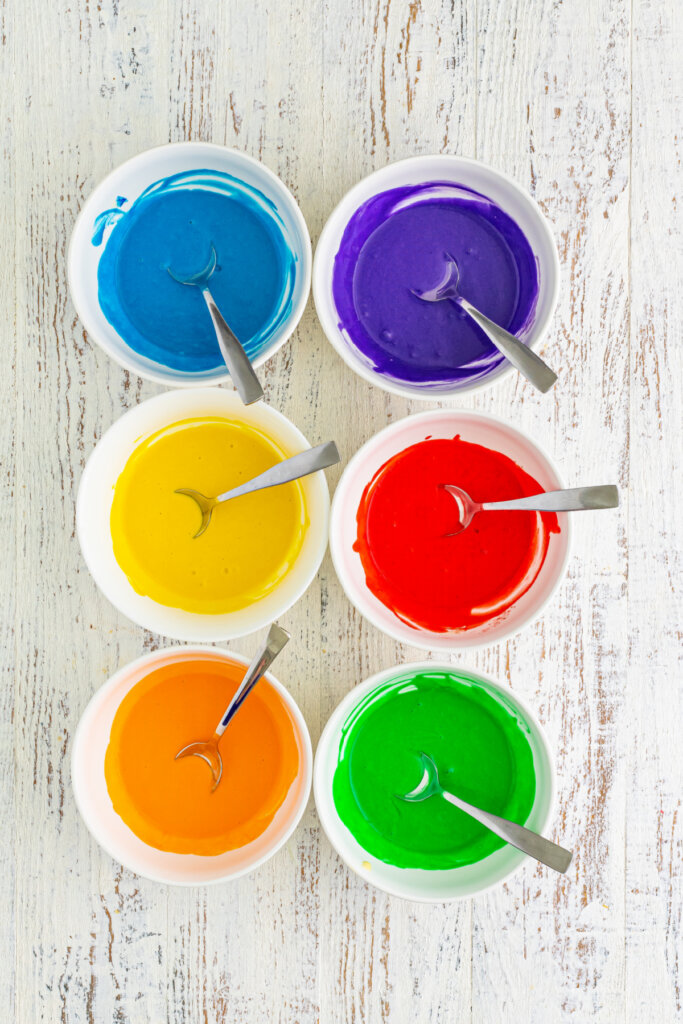 assorted colors of pancake batter in separate bowls