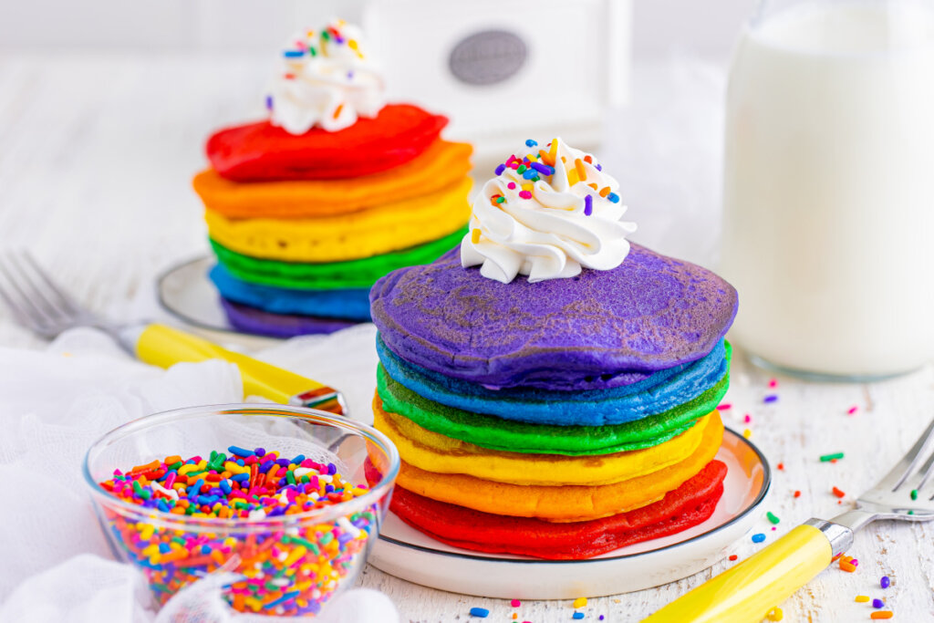 rainbow pancakes stacked on plate