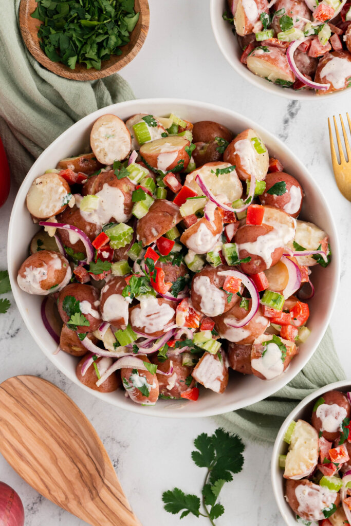 white serving bowl filled with red potato salad