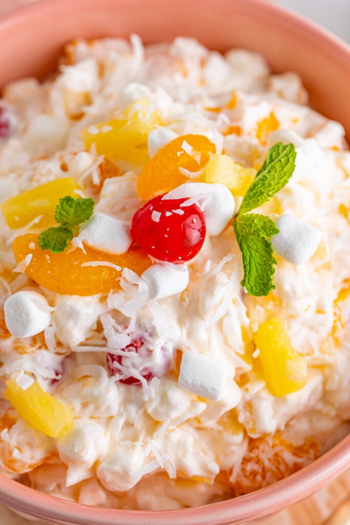 closeup of ambrosia salad in pink bowl