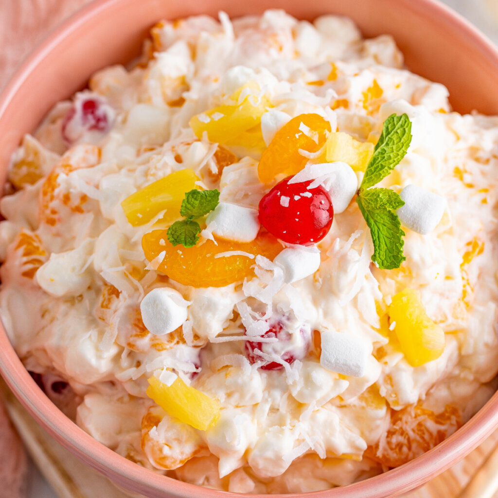 closeup of ambrosia salad in pink bowl