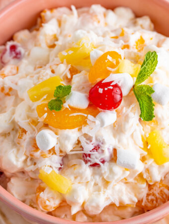 closeup of ambrosia salad in pink bowl