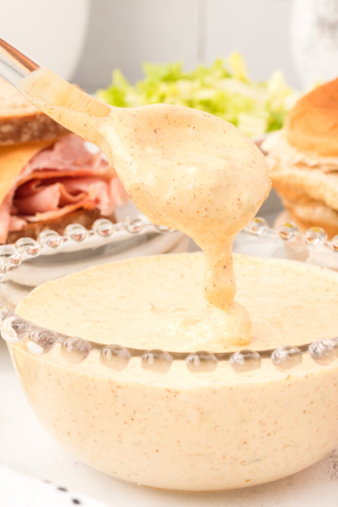 big mac sauce pouring off a spoon into a bowl