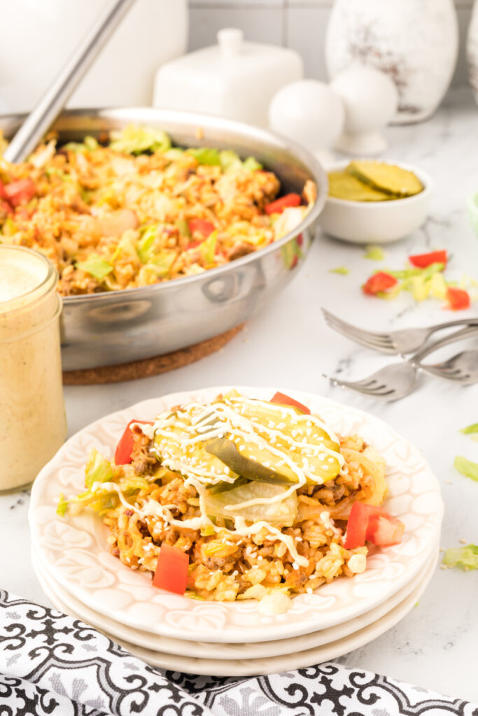 cheeseburger fried rice on plate with skillet in background