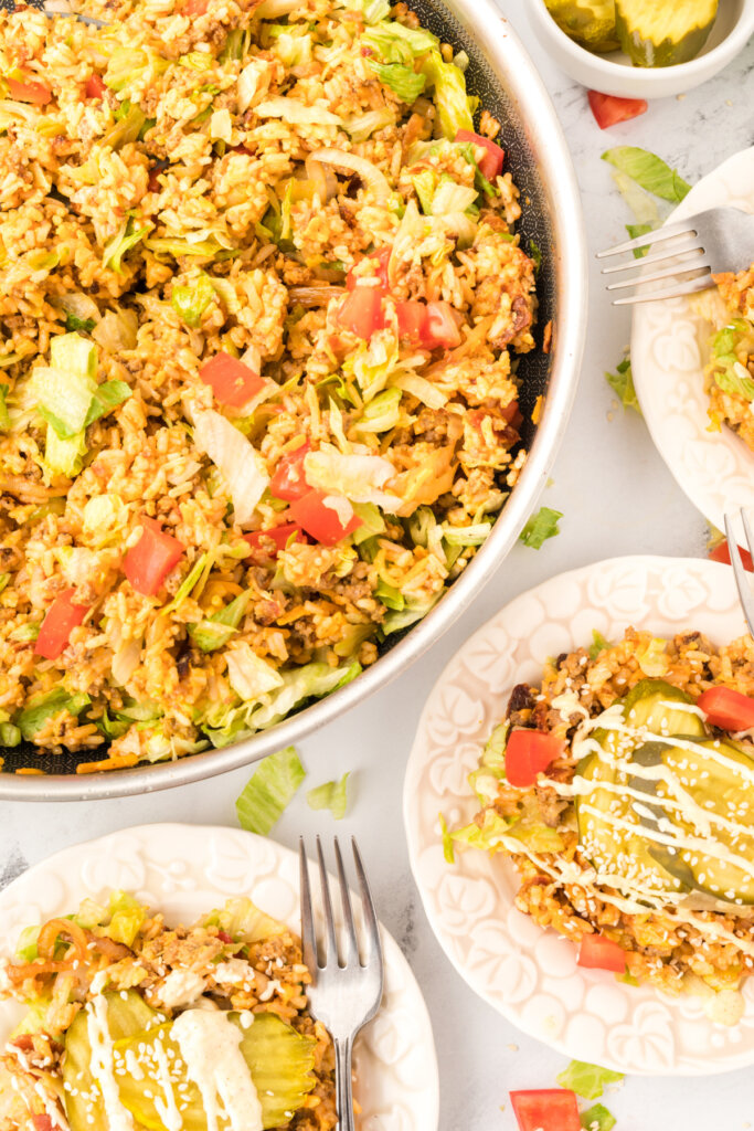 skillet and plates with cheeseburger fried rice