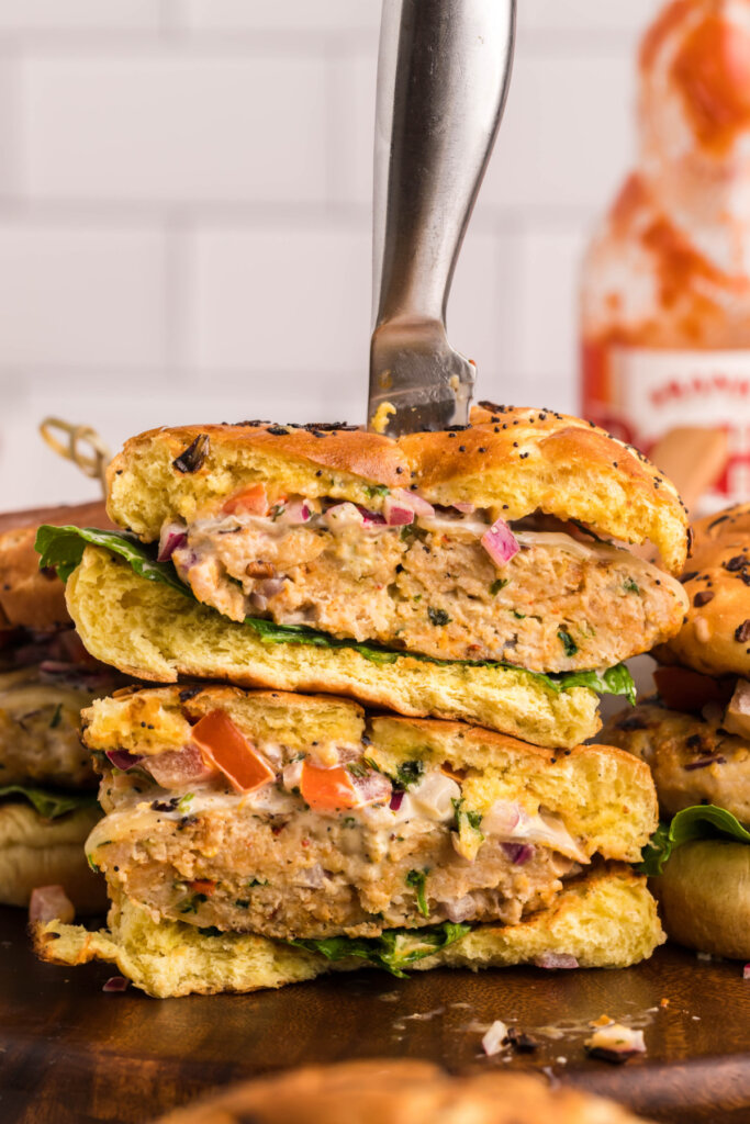 chicken burger cut in half and stcked with a knife stabbed through