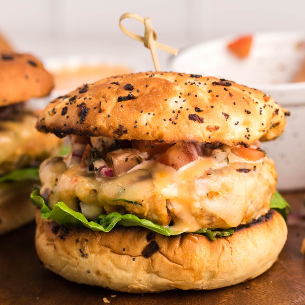 closeup of a chicken burger on cutting board