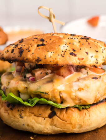 closeup of a chicken burger on cutting board