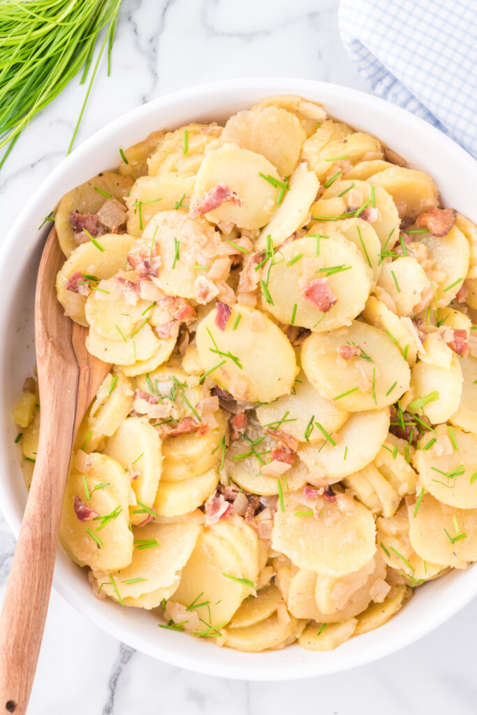 german potato salad in white bowl