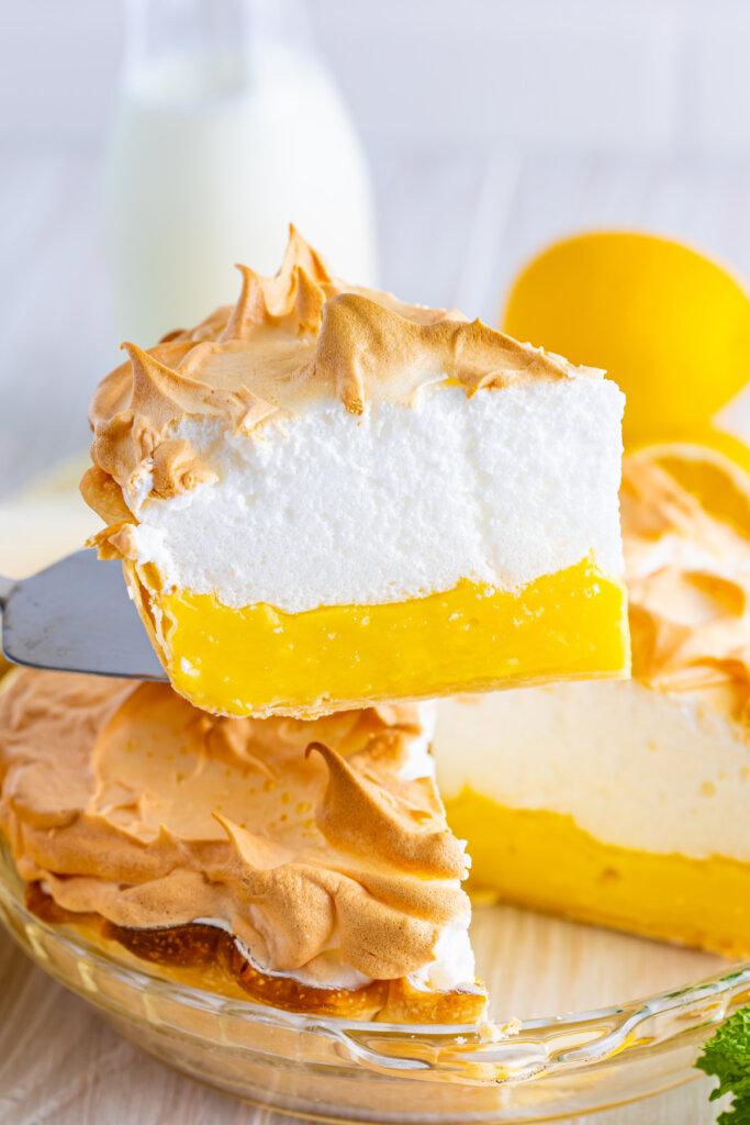slice of lemon meringue pie being lifted out of the pie plate
