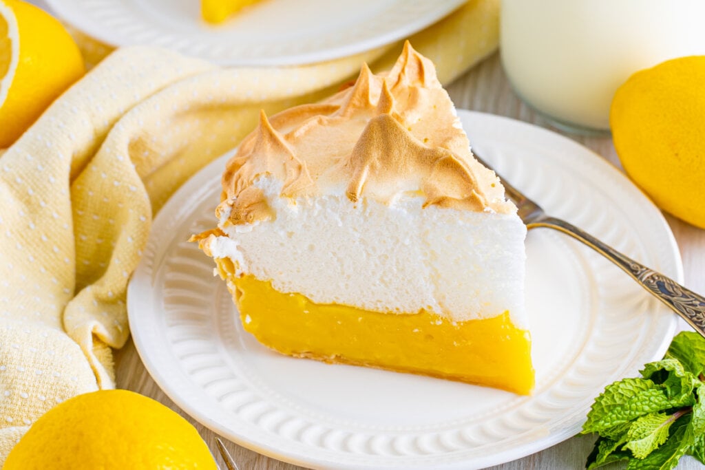 slice of lemon meringue pie on plate