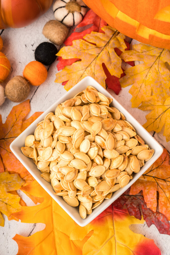 looking down onto a square bowl holding roasted pumpkin seeds