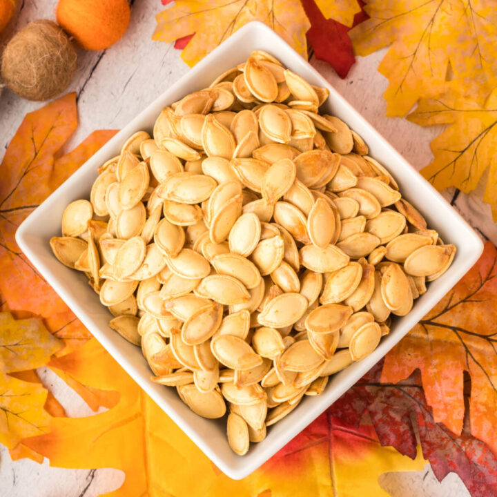 roasted pumpkin seeds in square white bowl